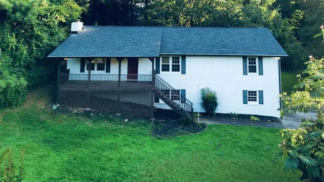 a aerial view of a house with table and chairs under an umbrella