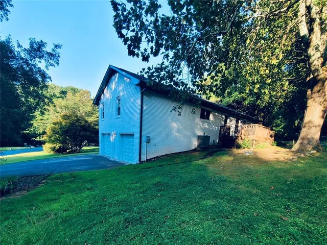 a white house sitting in middle of the grass