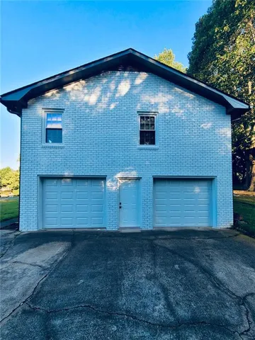 a view of porch with green trees in front