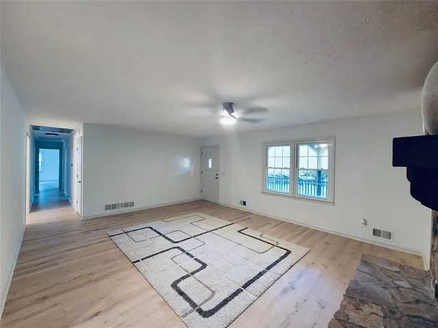 a large kitchen with a large counter top sink stainless steel appliances and cabinets