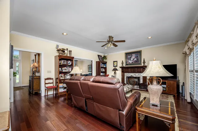 a kitchen with stainless steel appliances kitchen island granite countertop a sink a stove and a refrigerator