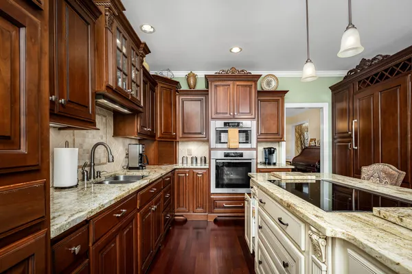 a bathroom with a granite countertop sink a bathtub and a mirror