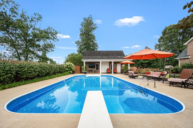 a view of a dining room with furniture and chandelier