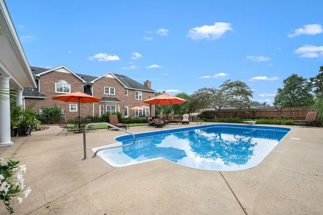 an aerial view of residential houses with outdoor space and lake view