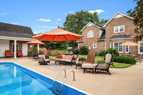 an aerial view of a house with a swimming pool