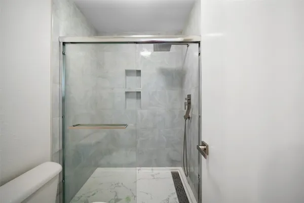 a bathroom with a glass shower door