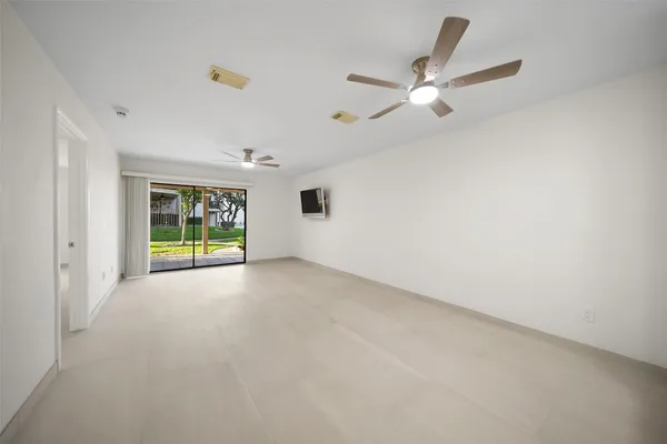 a view of a livingroom with a ceiling fan and window