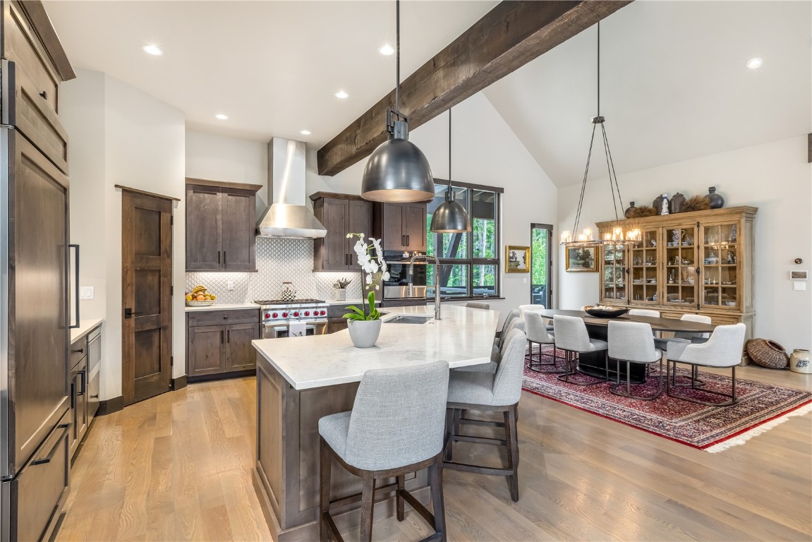 380 River Park Drive Breckenridge, CO 80424 - Photo 7 of 45 a large kitchen with a table chairs refrigerator and cabinets