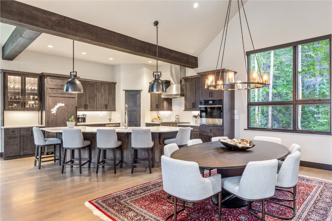380 River Park Drive Breckenridge, CO 80424 - Photo 9 of 45 a dining room with furniture a rug a potted plant and a chandelier