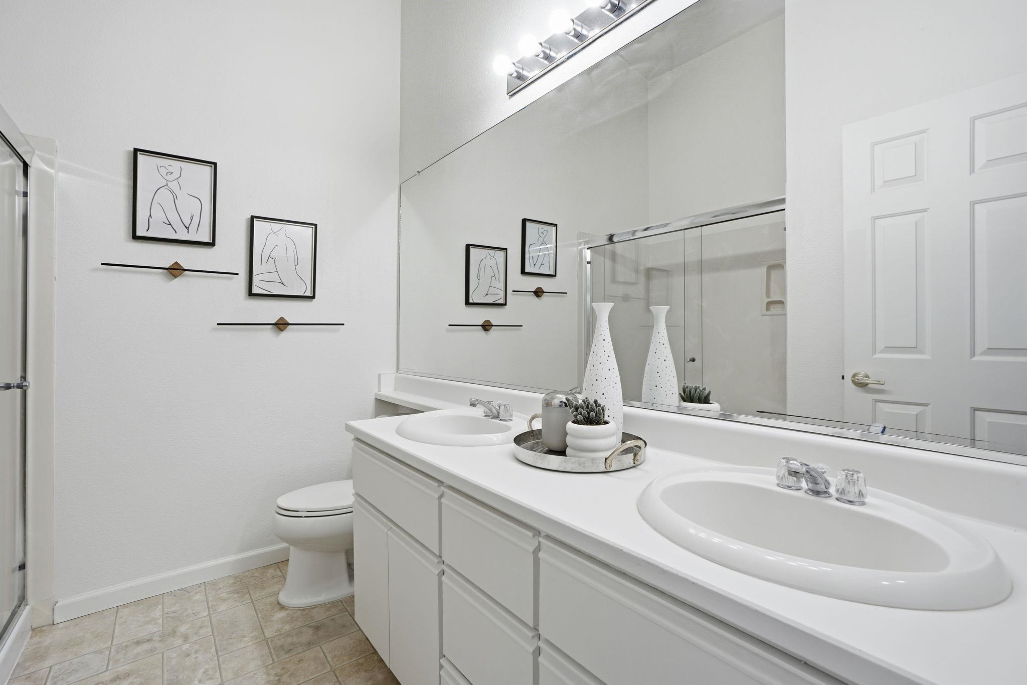 2586 Oak Road, Unit 229 Walnut Creek, CA 94597 - Photo 23 of 39 a bathroom with a double vanity sink and a mirror