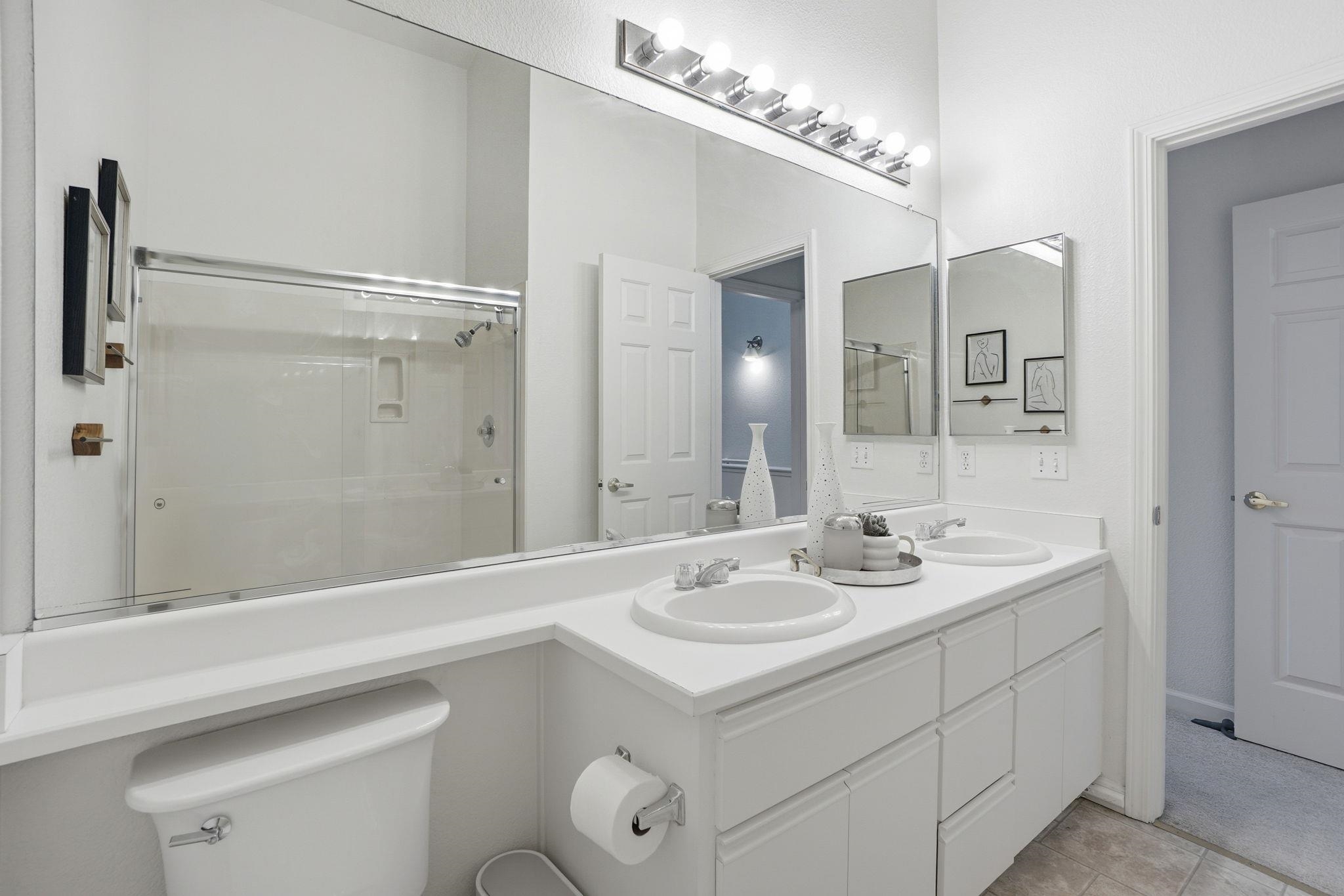2586 Oak Road, Unit 229 Walnut Creek, CA 94597 - Photo 24 of 39 a bathroom with a sink a toilet a mirror and shower