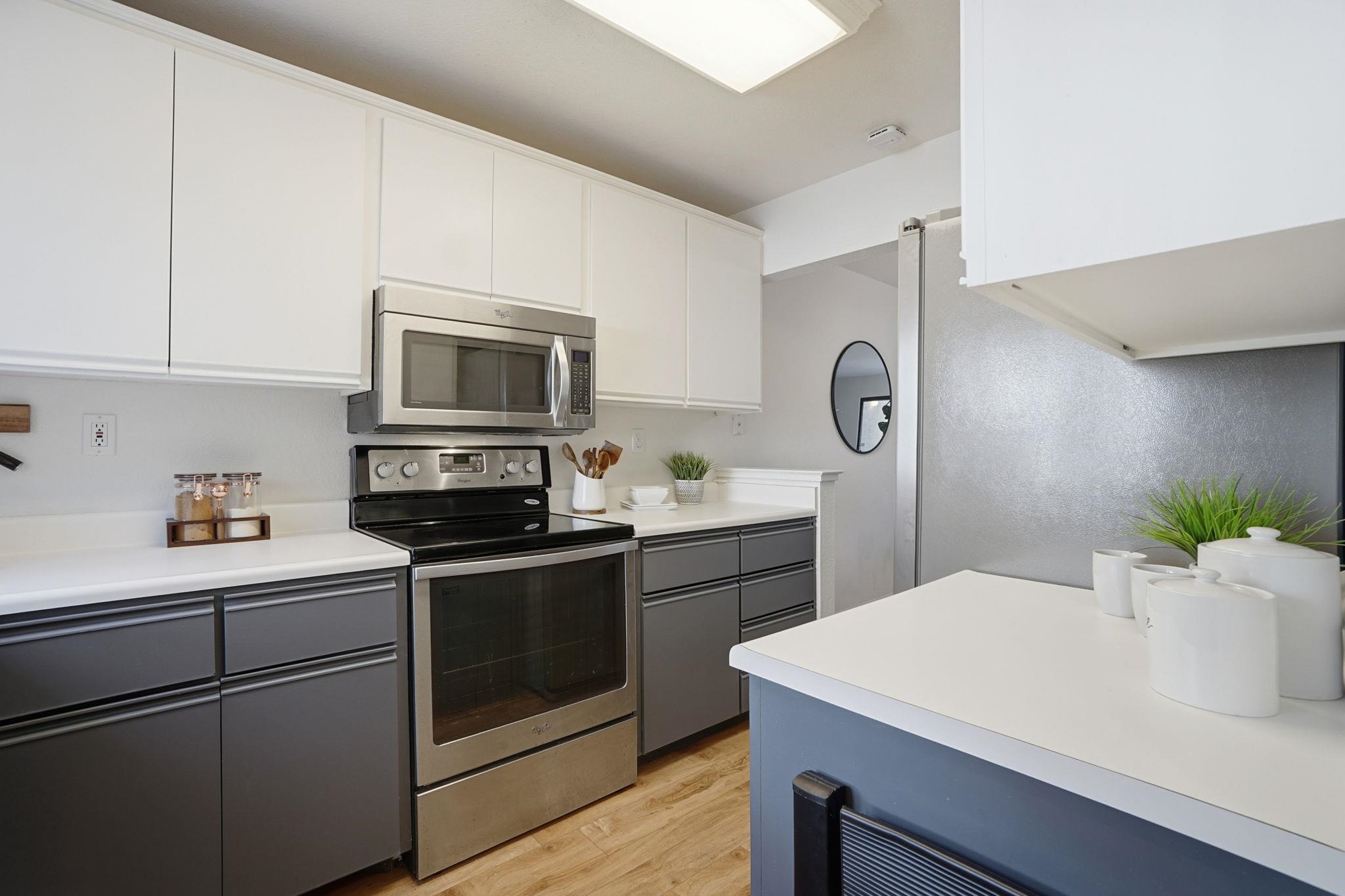 2586 Oak Road, Unit 229 Walnut Creek, CA 94597 - Photo 5 of 39 a kitchen with a sink a stove and cabinets