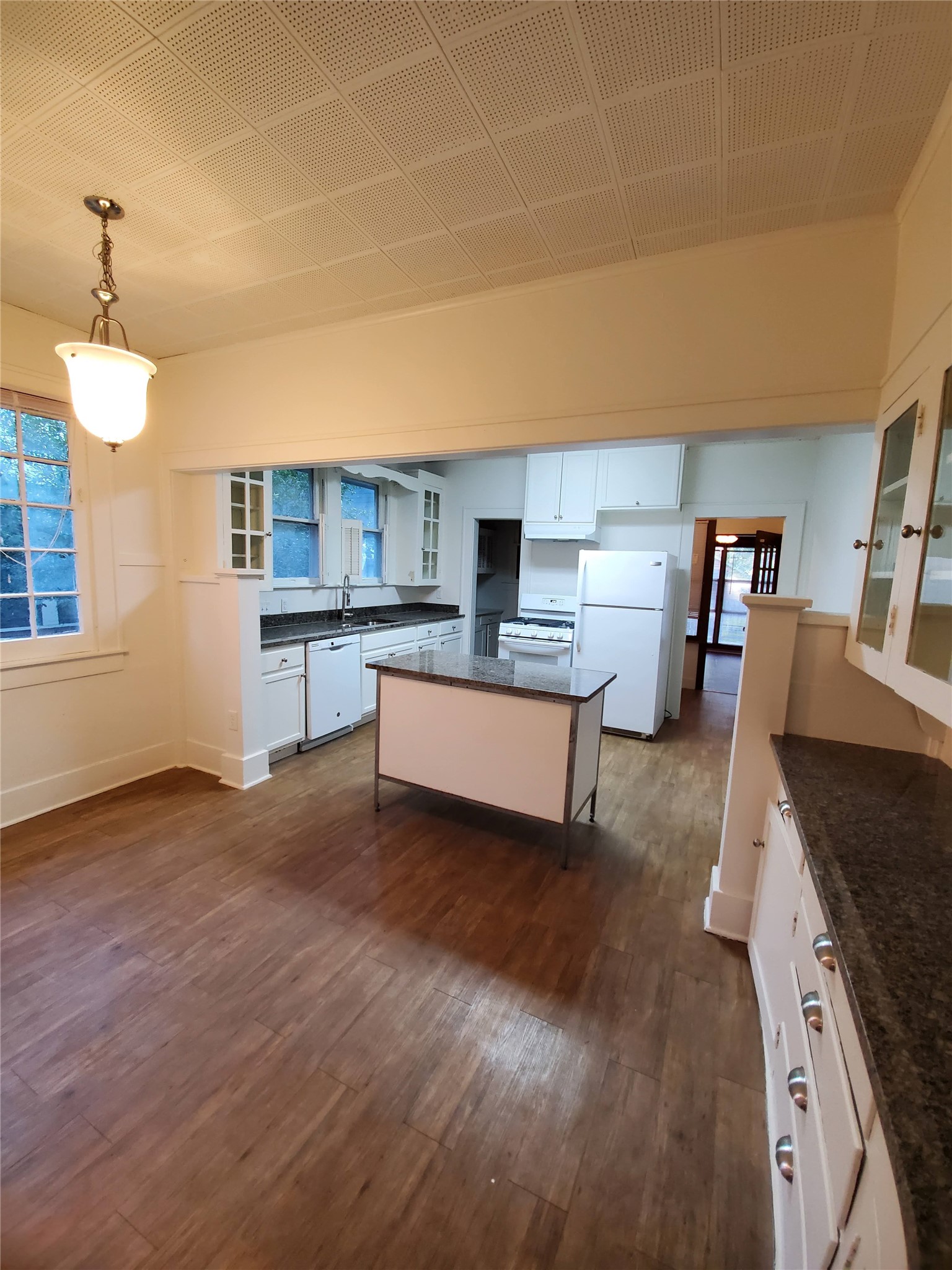 4113 Speedway Austin, TX 78751 - Photo 20 of 31 Rich wood flooring connects the dining area to a functional kitchen workspace.