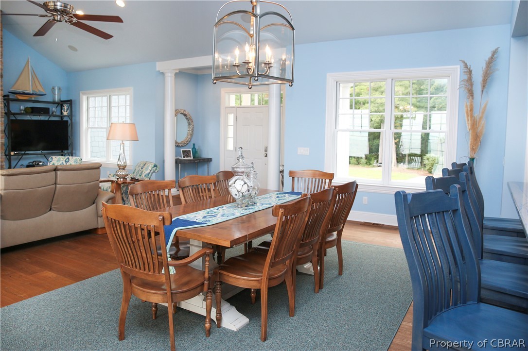 1000 Queenstown Road Lancaster, VA 22503 - Photo 34 of 49 a dining room with furniture a chandelier and wooden floor
