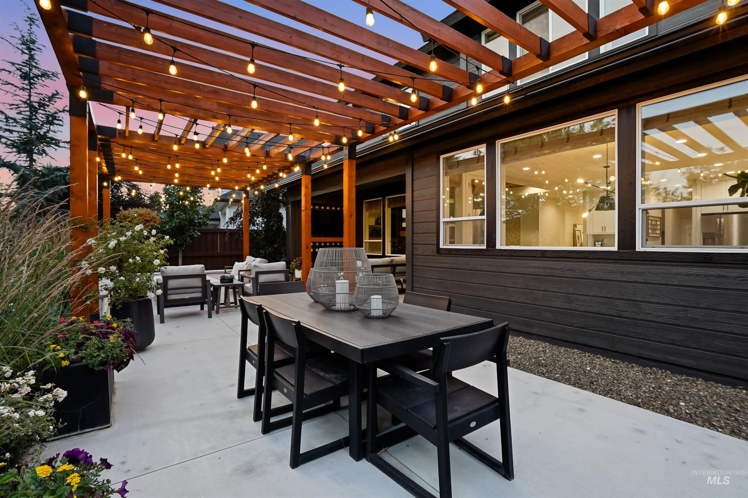 4323 West Ladle Rpds Drive Meridian, ID 83646 - Photo 43 of 49 Expansive concrete patio featuring a wooden pergola with string lighting