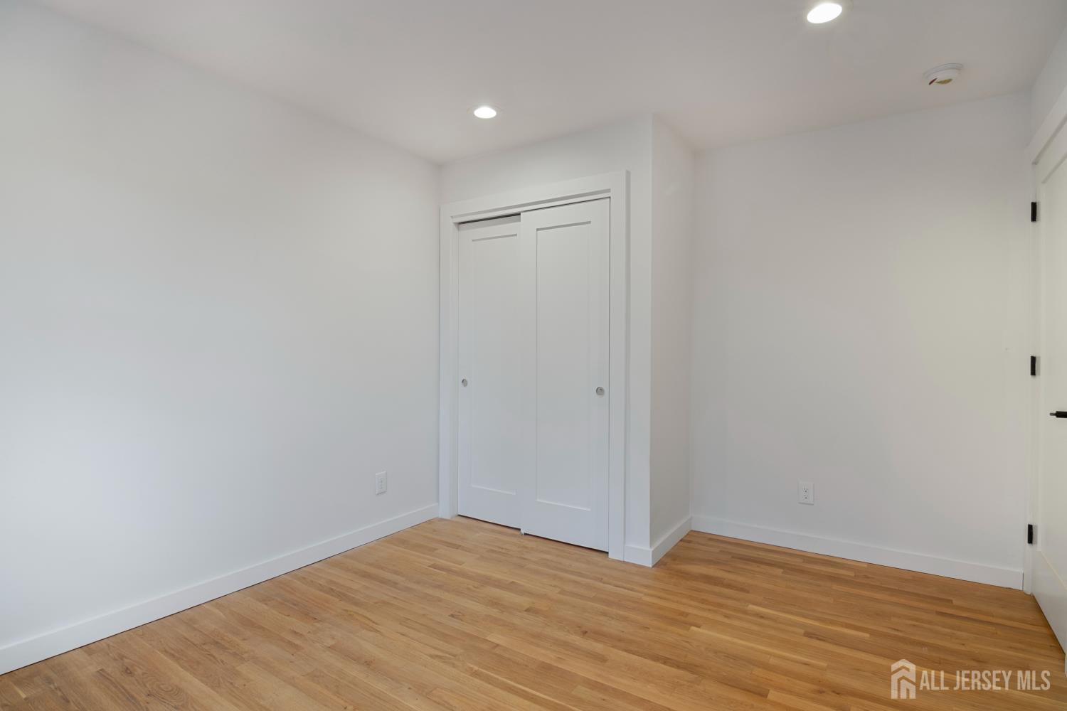 4 Morris Avenue, Unit 2A Edison, NJ 08837 - Photo 17 of 27 a view of empty room with wooden floor