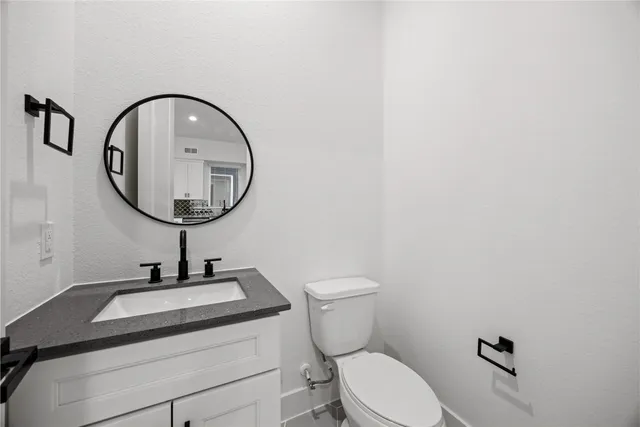a view of an empty room with glass door and wooden floor