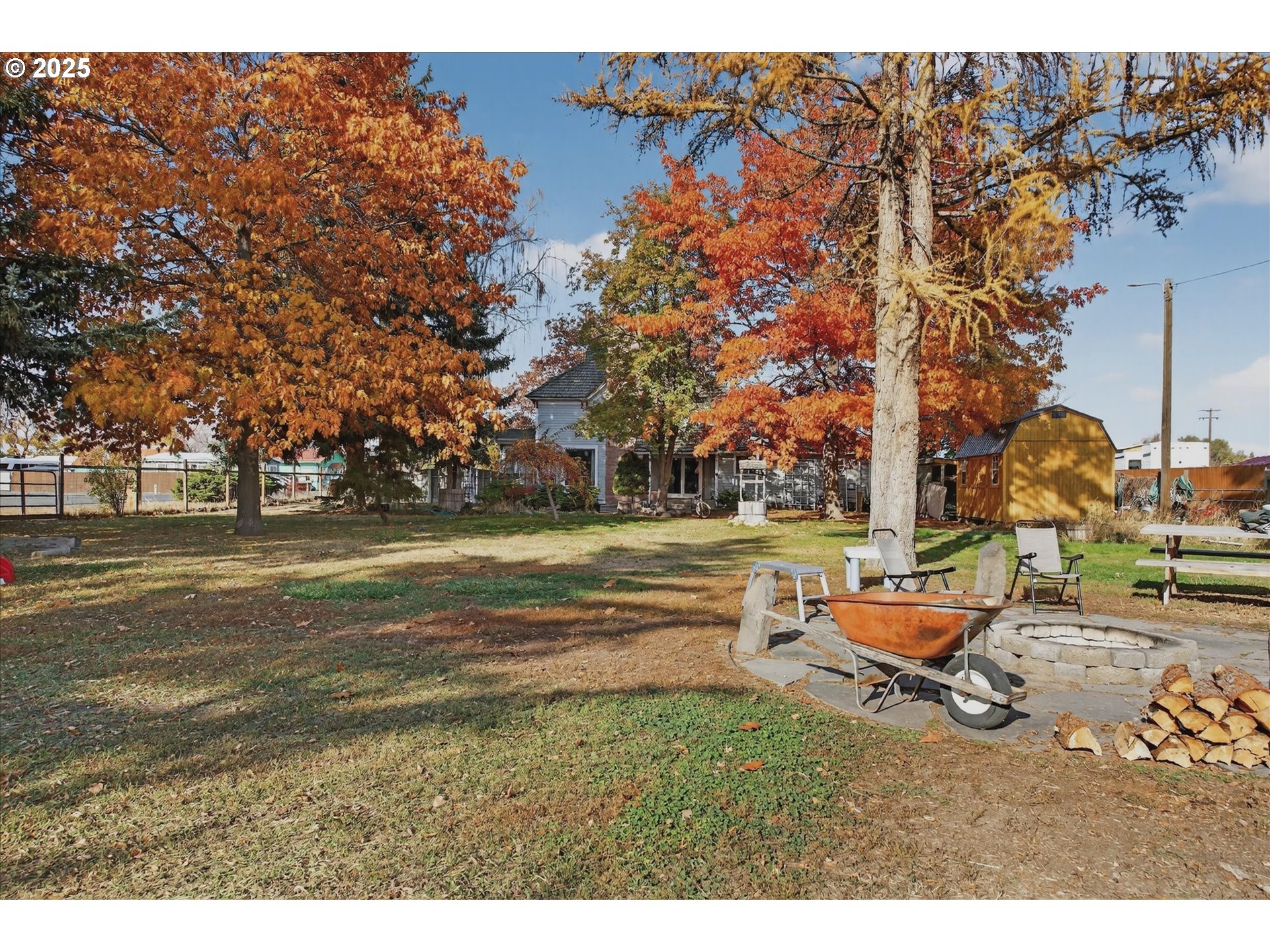 1490 10th Street Baker City, OR 97814 - Photo 14 of 24 a backyard of a house with barbeque oven table and chairs