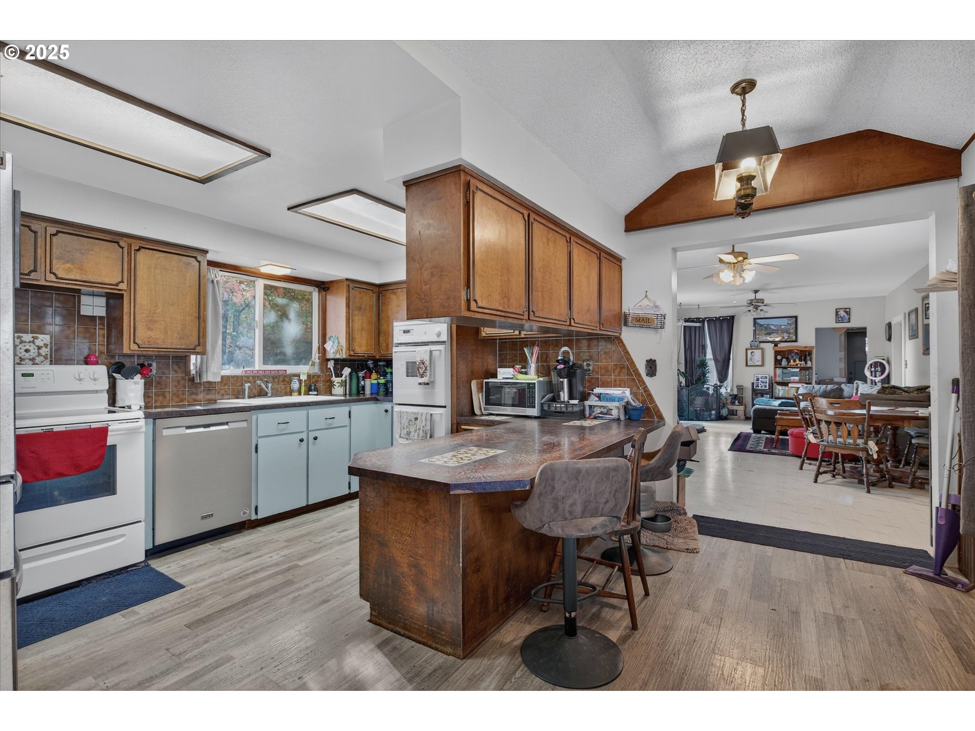 1490 10th Street Baker City, OR 97814 - Photo 16 of 24 a kitchen with stainless steel appliances kitchen island granite countertop a table chairs and a refrigerator