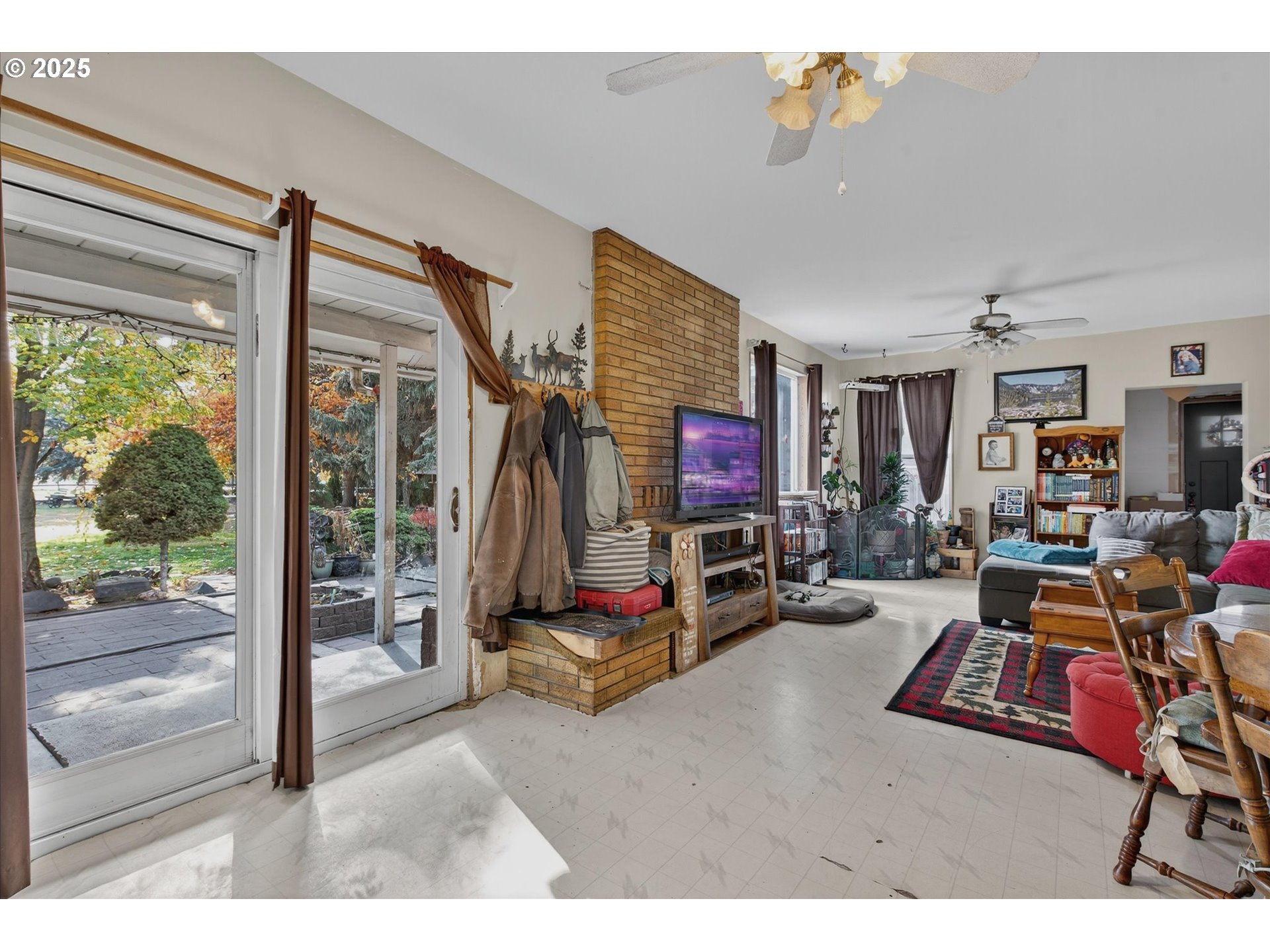1490 10th Street Baker City, OR 97814 - Photo 18 of 24 a living room with furniture a flat screen tv and a floor to ceiling window