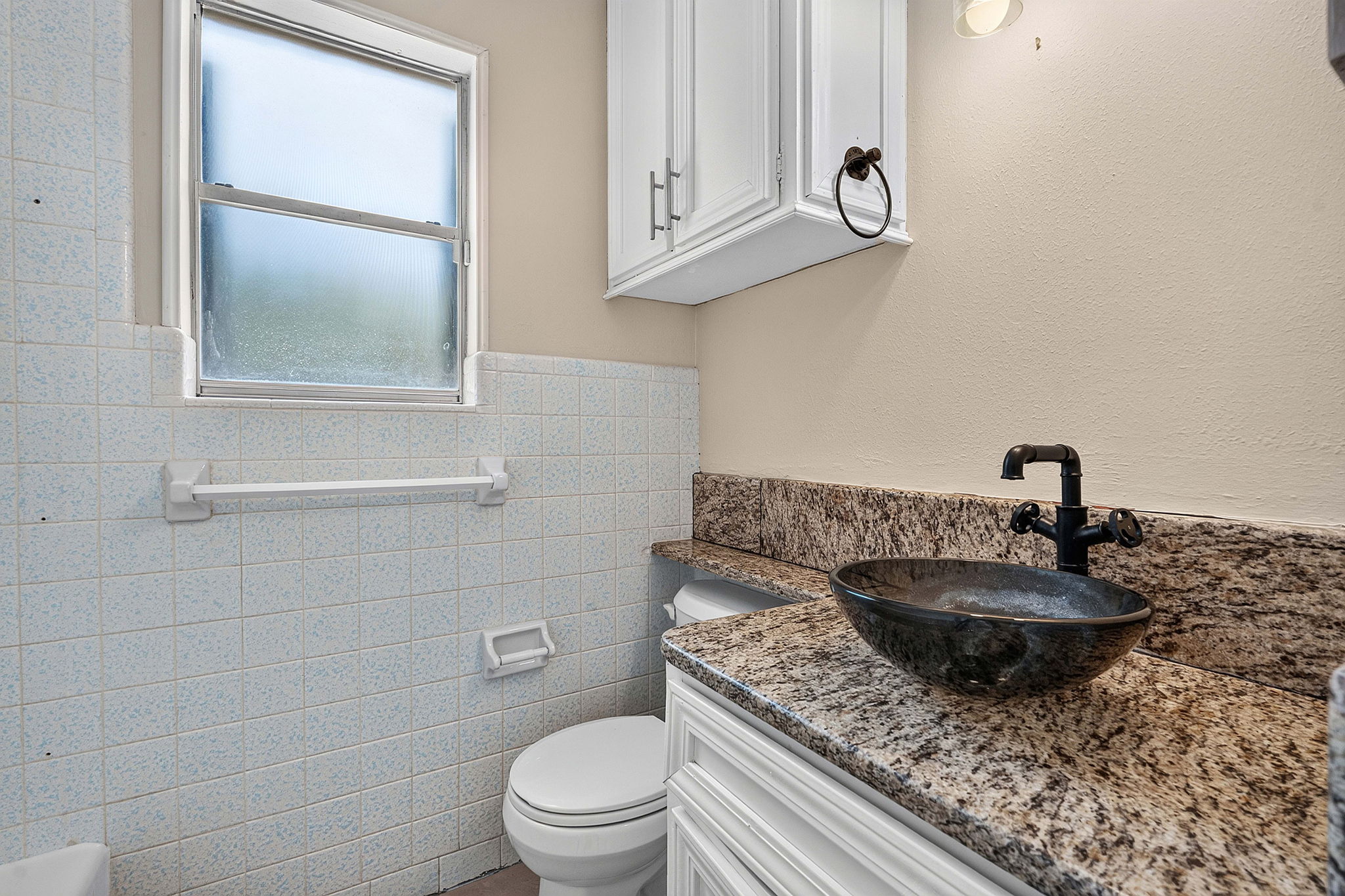 3809 Wyldwood Road Austin, TX 78739 - Photo 17 of 40 Polished granite countertops complement classic tiled walls in this thoughtfully designed bathroom space.