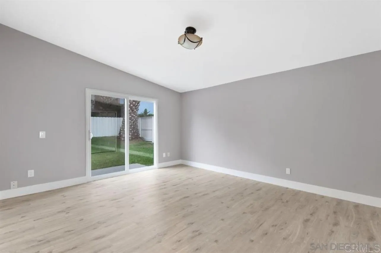5957 Avenida Chamnez La Jolla, CA 92037 - Photo 11 of 28 wooden floor in an empty room with a window