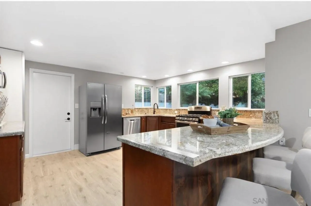 5957 Avenida Chamnez La Jolla, CA 92037 - Photo 16 of 28 a kitchen with a sink and cabinets
