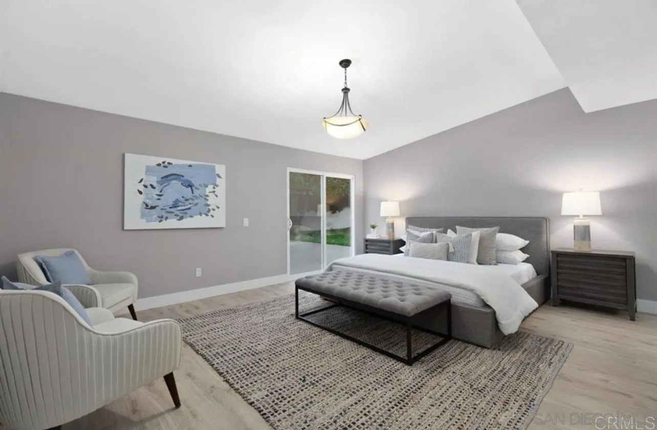 5957 Avenida Chamnez La Jolla, CA 92037 - Photo 17 of 28 a bedroom with a large bed rug and a window