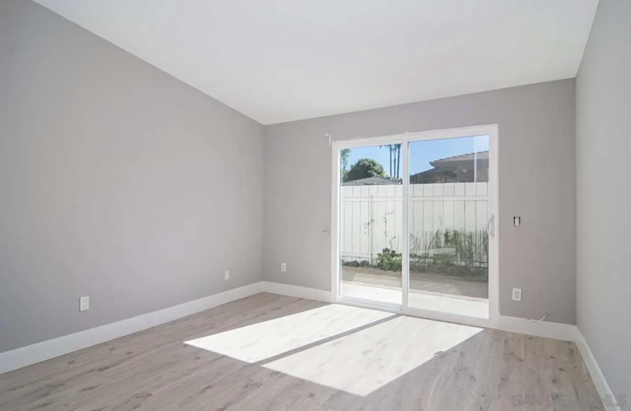 5957 Avenida Chamnez La Jolla, CA 92037 - Photo 18 of 28 a view of an empty room with wooden floor and a window