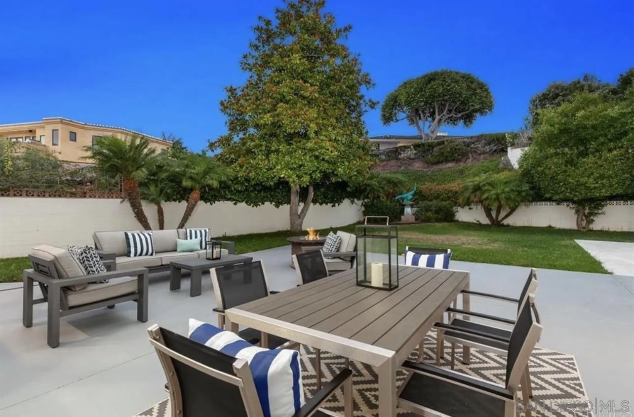 5957 Avenida Chamnez La Jolla, CA 92037 - Photo 20 of 28 a view of a patio with table and chairs and potted plants