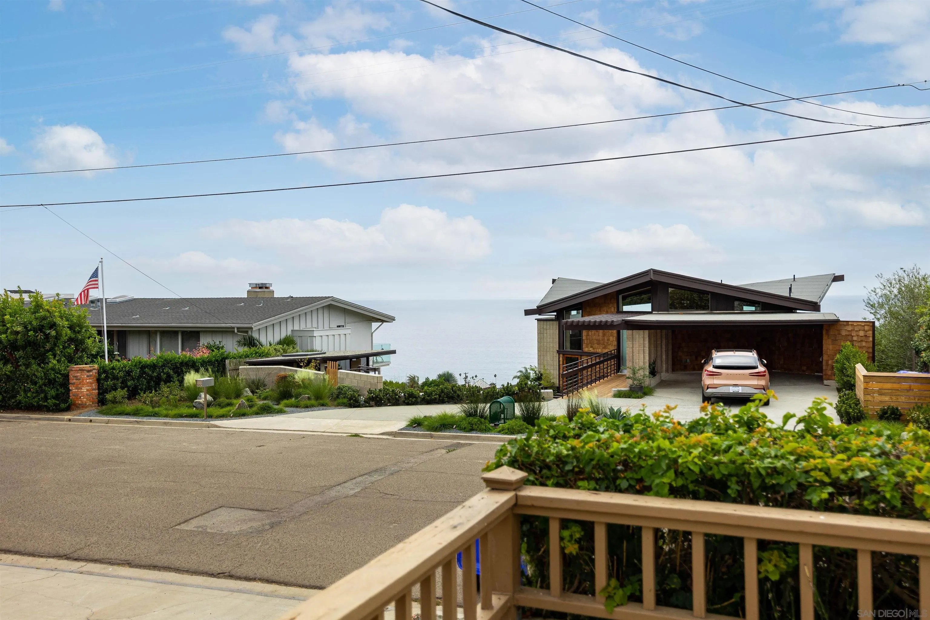 5957 Avenida Chamnez La Jolla, CA 92037 - Photo 22 of 28 a front view of a house with a yard