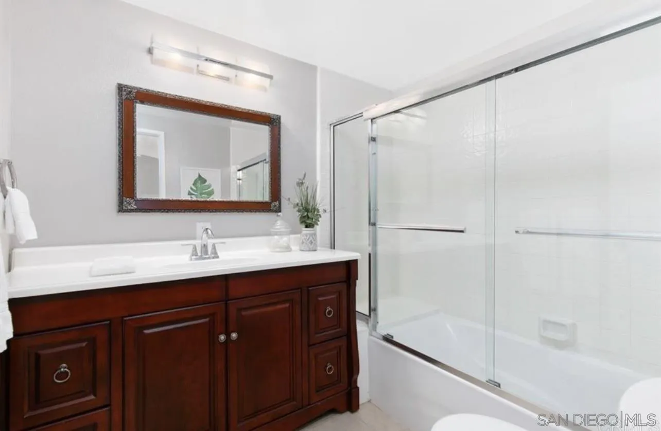 5957 Avenida Chamnez La Jolla, CA 92037 - Photo 9 of 28 a bathroom with a double vanity sink mirror and shower