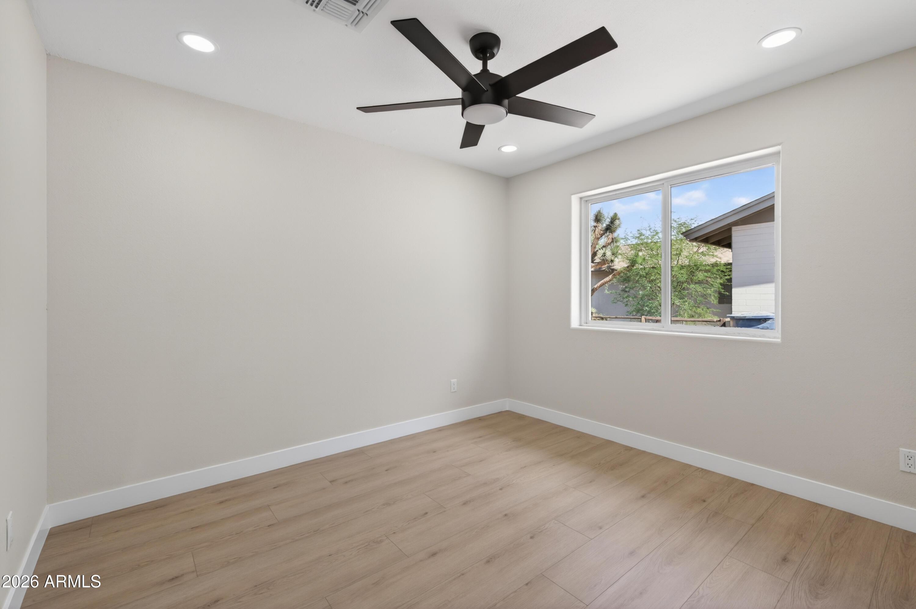3422 South Terrace Road Tempe, AZ 85282 - Photo 23 of 43 an empty room with wooden floor and ceiling fan