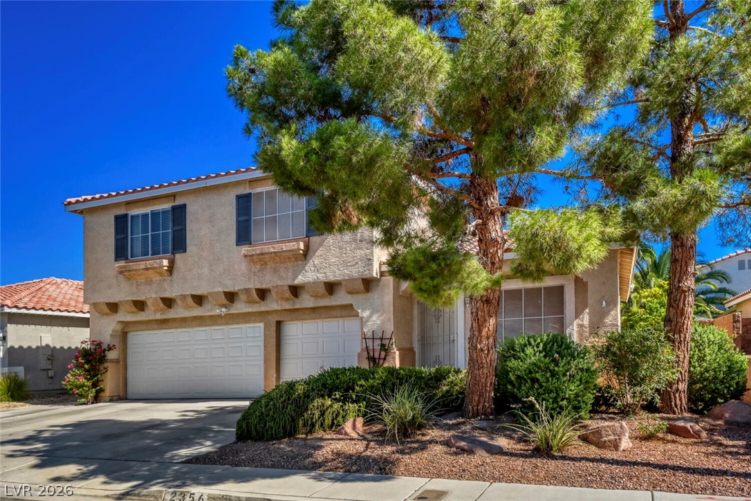 2356 Tilden Way Henderson, NV 89074 - Photo 1 of 30 Two-story residence with a two-car garage, mature trees, and landscaped front yard for inviting curb appeal.