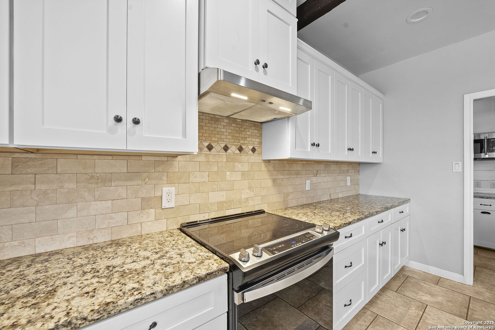 622 North Dickson Street Poth, TX 78147 - Photo 13 of 60 a kitchen with white cabinets and appliances