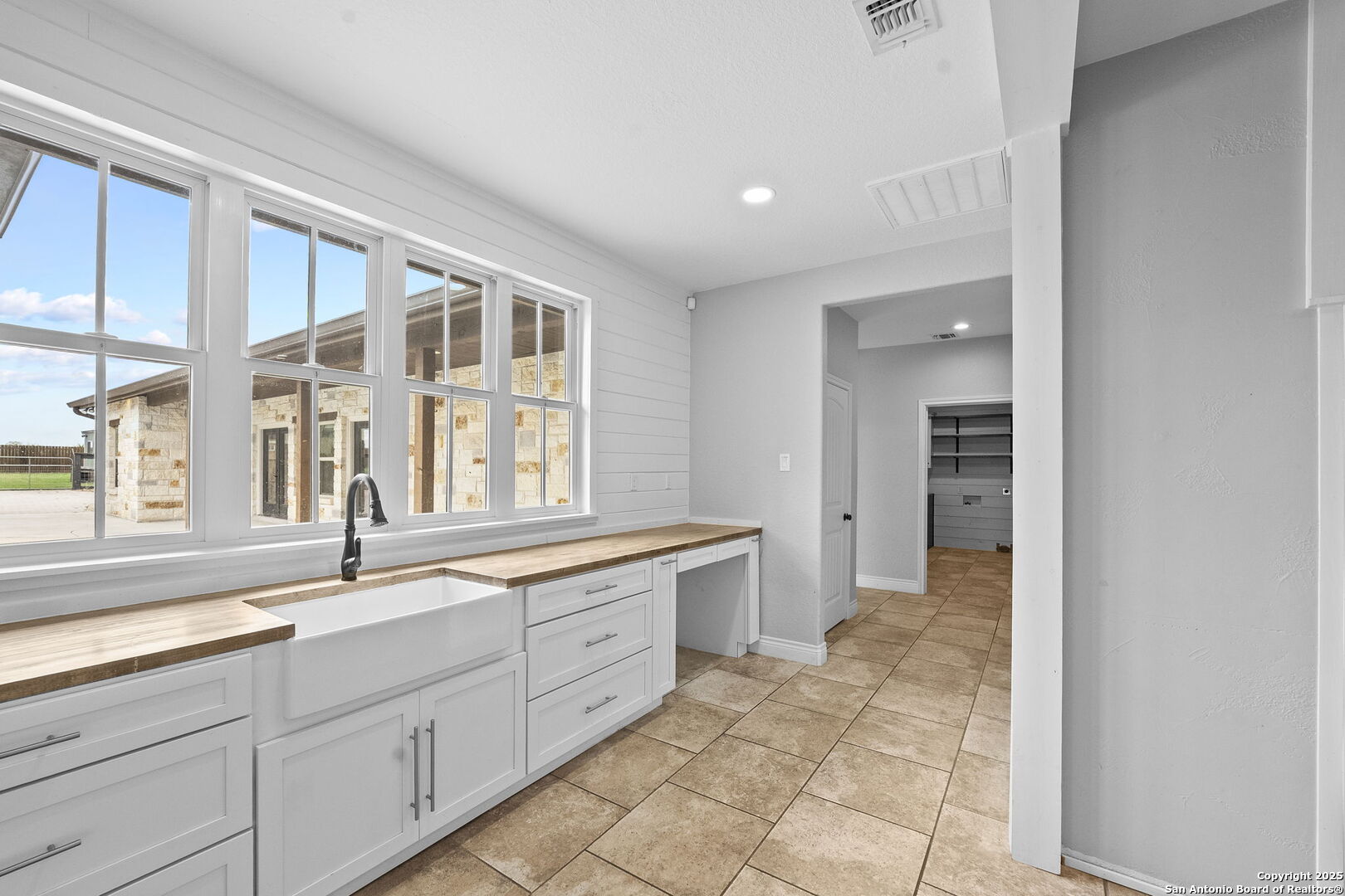 622 North Dickson Street Poth, TX 78147 - Photo 17 of 60 a large white kitchen with a sink and cabinets