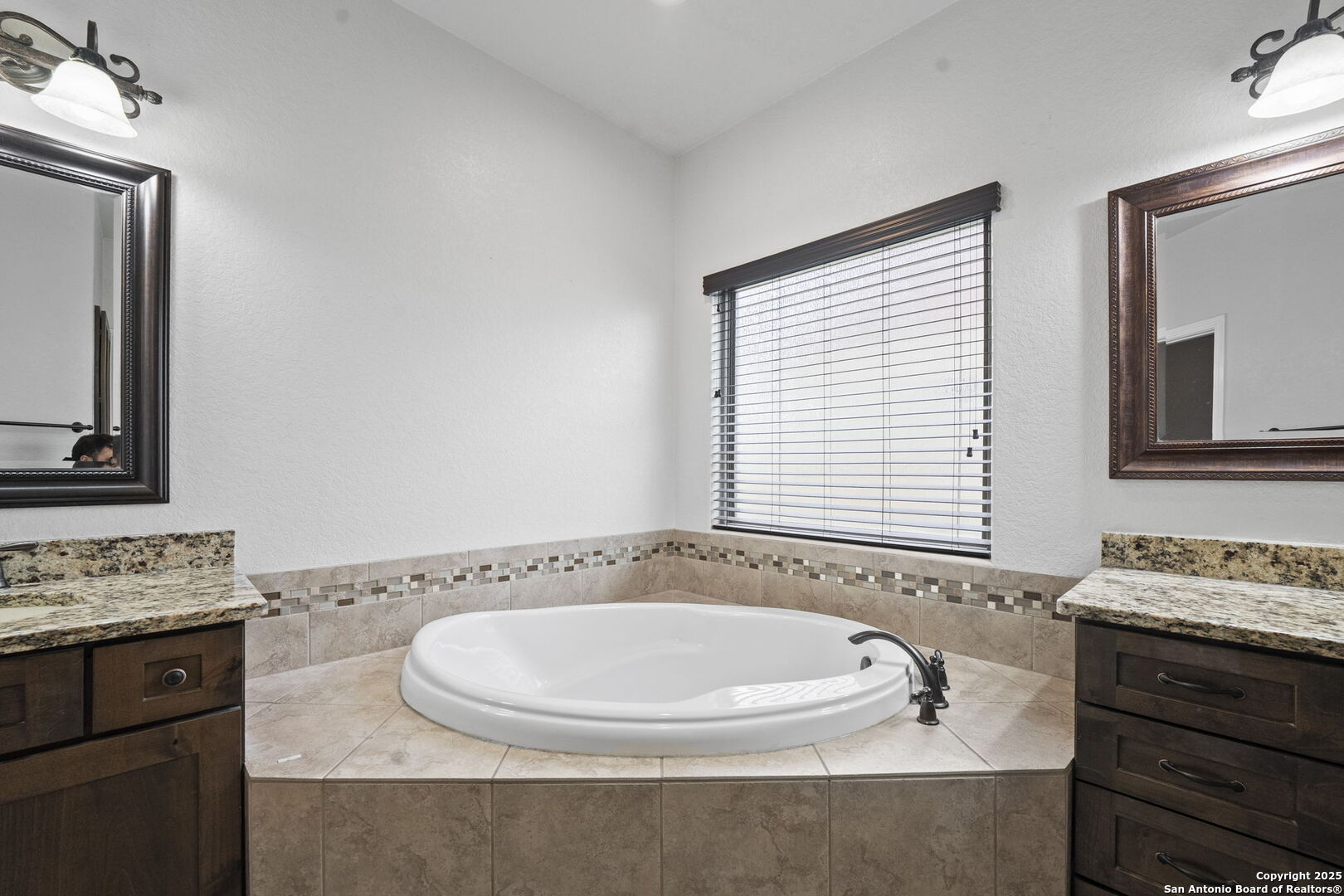 622 North Dickson Street Poth, TX 78147 - Photo 28 of 60 a bathroom with a granite countertop sink and a mirror