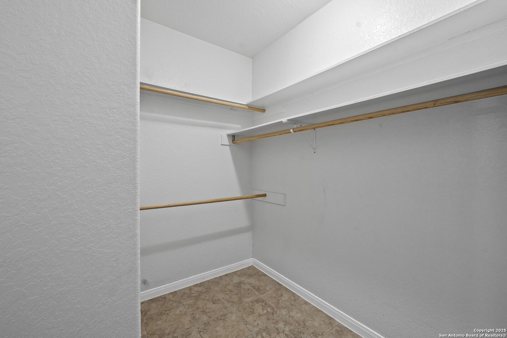 622 North Dickson Street Poth, TX 78147 - Photo 33 of 60 a view of walk in closet with empty racks