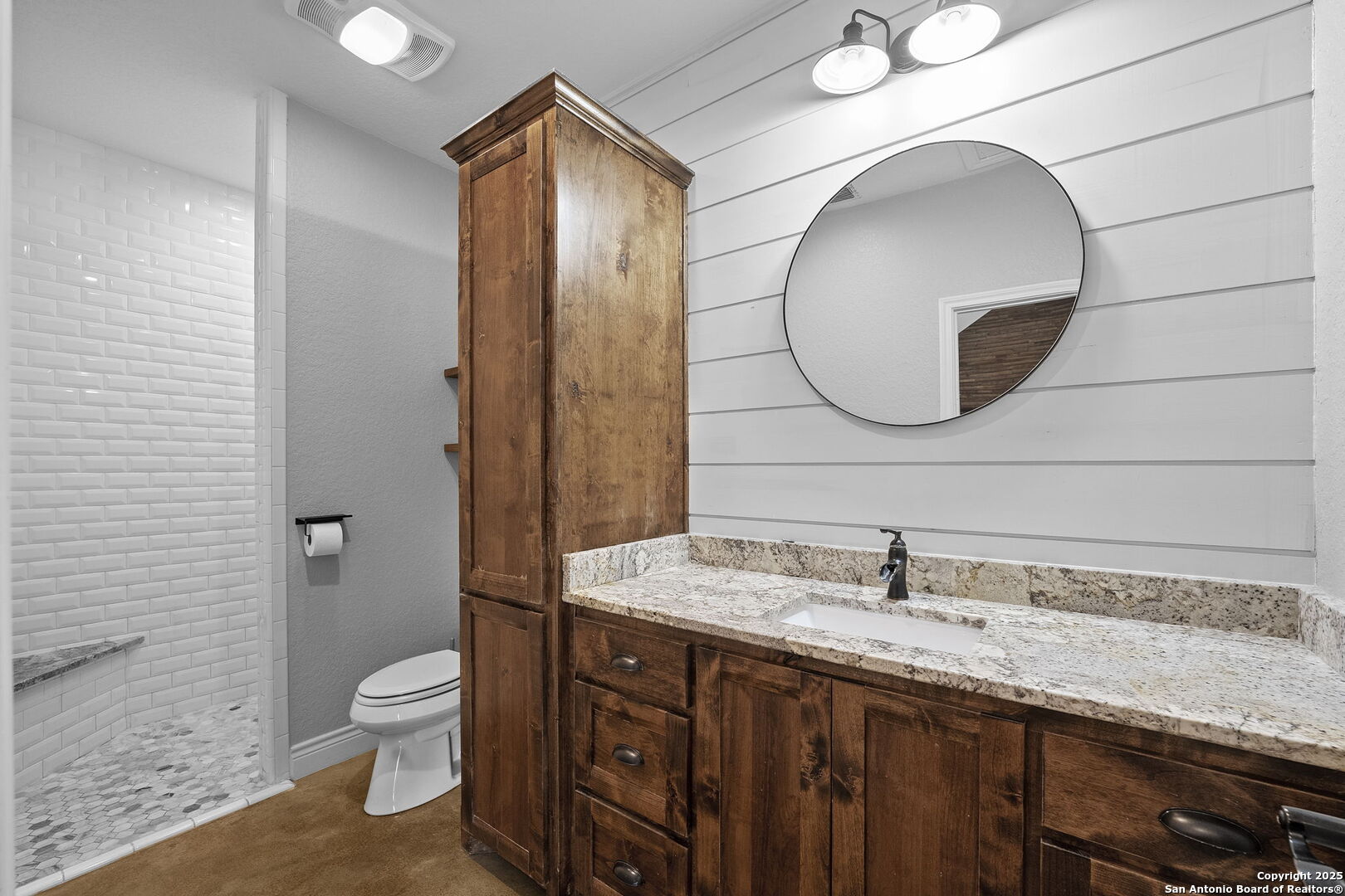 622 North Dickson Street Poth, TX 78147 - Photo 46 of 60 a bathroom with a granite countertop sink and a mirror