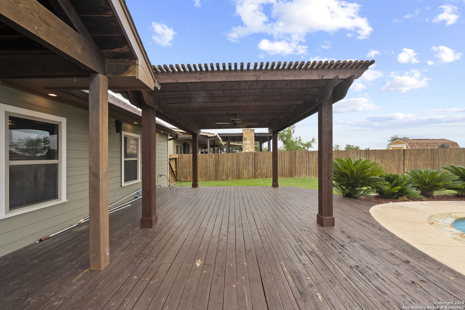 622 North Dickson Street Poth, TX 78147 - Photo 51 of 60 a view of a wooden deck with a garden