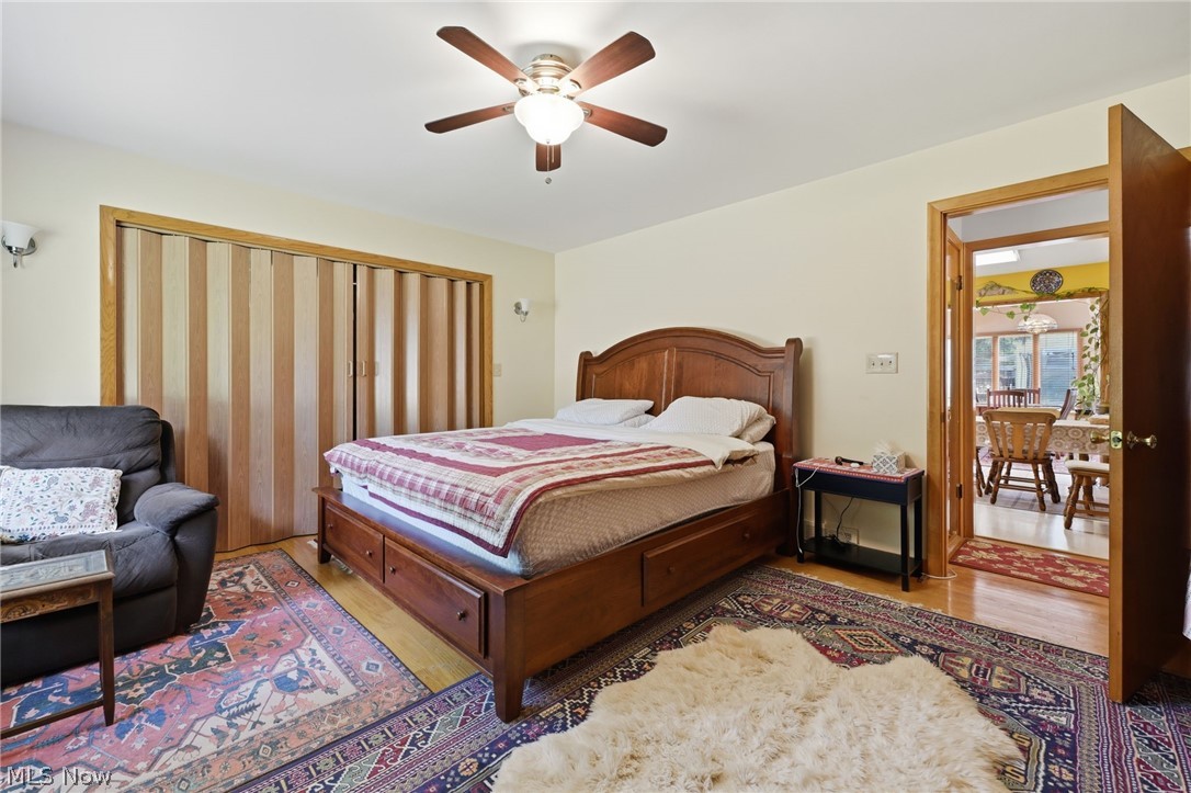 1499 Morris Road Kent, OH 44240 - Photo 4 of 41 Spacious room featuring light wood-finish flooring, a ceiling fan with integrated lighting, and a wide accordion-style closet system