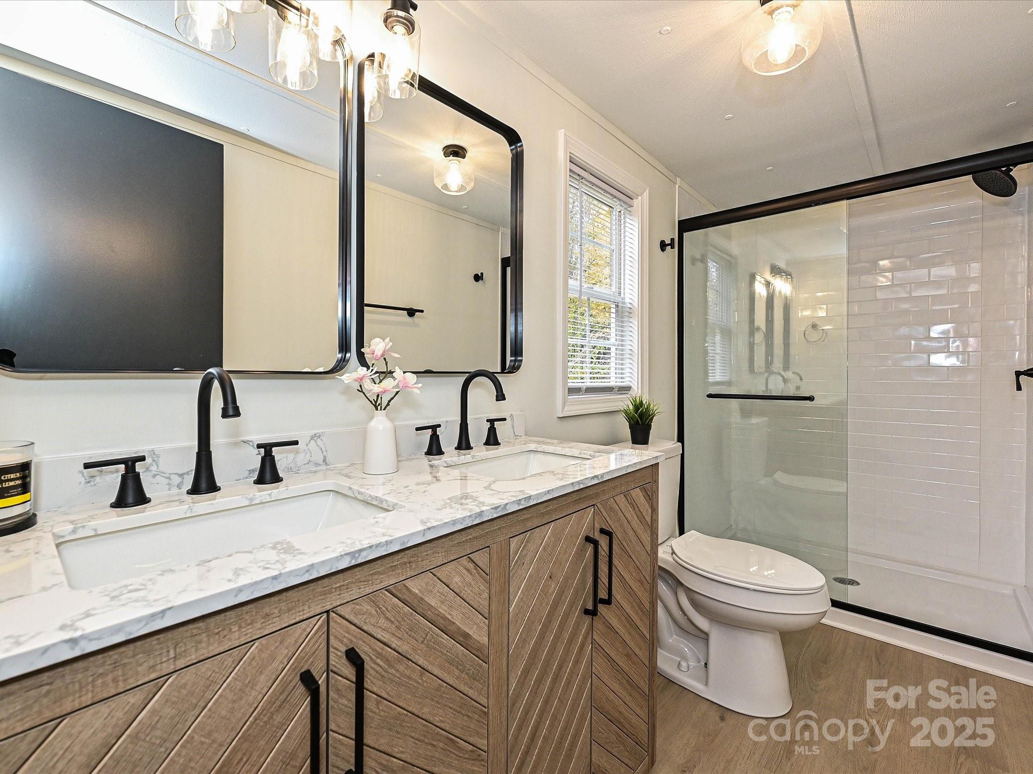 3318 Loop Road Lincolnton, NC 28092 - Photo 15 of 27 a bathroom with a granite countertop sink toilet and shower