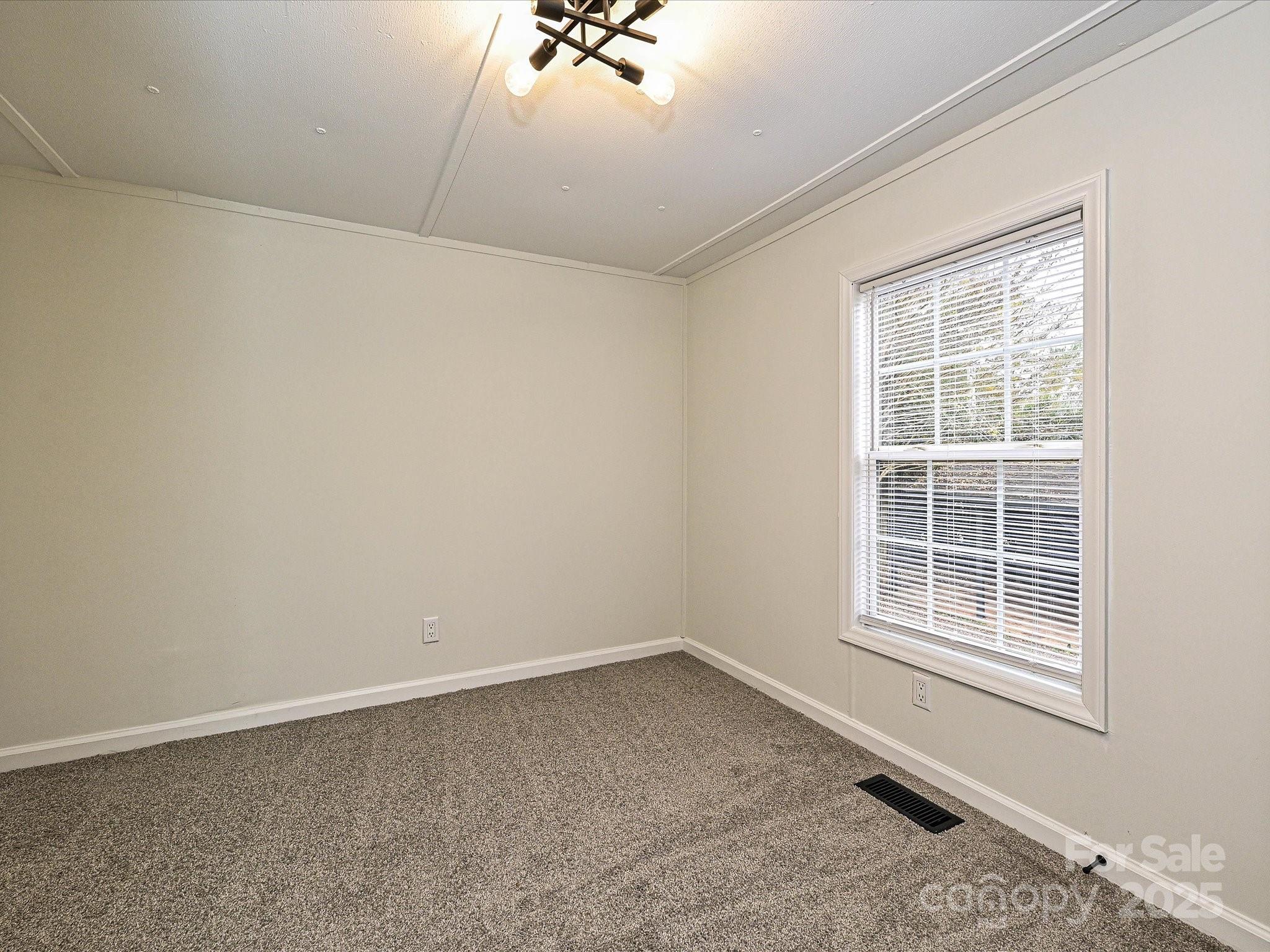 3318 Loop Road Lincolnton, NC 28092 - Photo 18 of 27 an empty room with a window