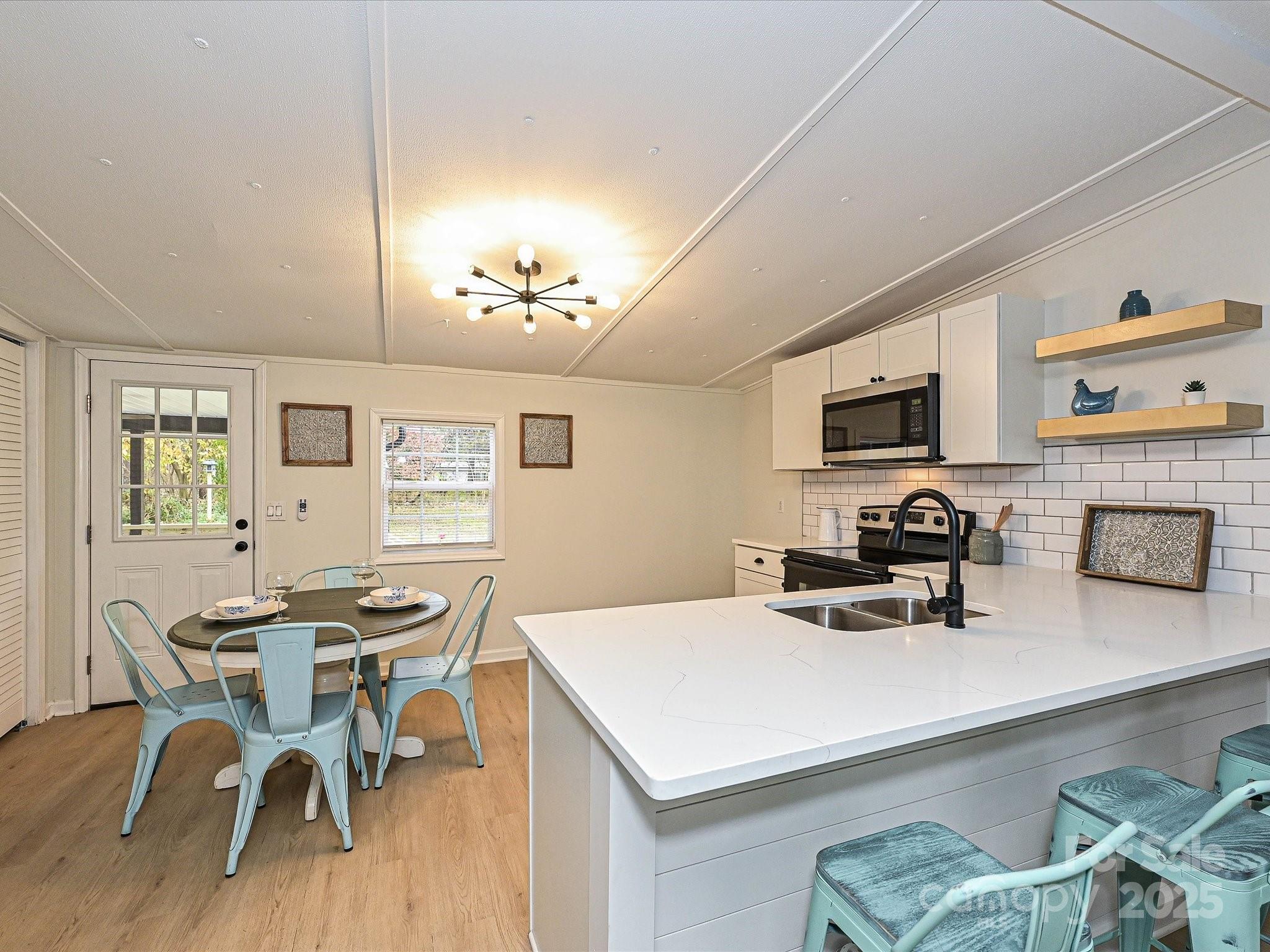 3318 Loop Road Lincolnton, NC 28092 - Photo 7 of 27 a kitchen with a table chairs and a refrigerator