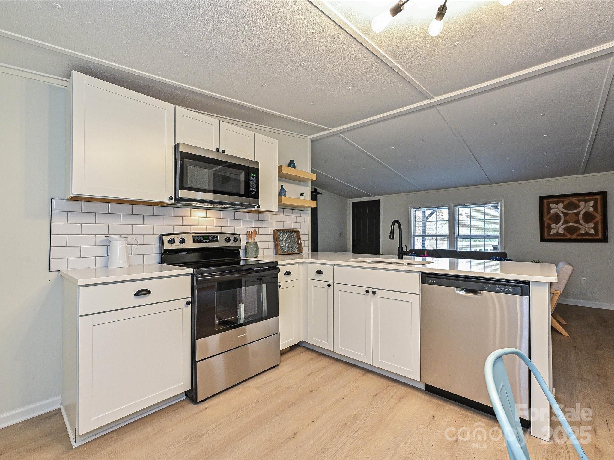 3318 Loop Road Lincolnton, NC 28092 - Photo 9 of 27 a kitchen with granite countertop appliances cabinets and a sink