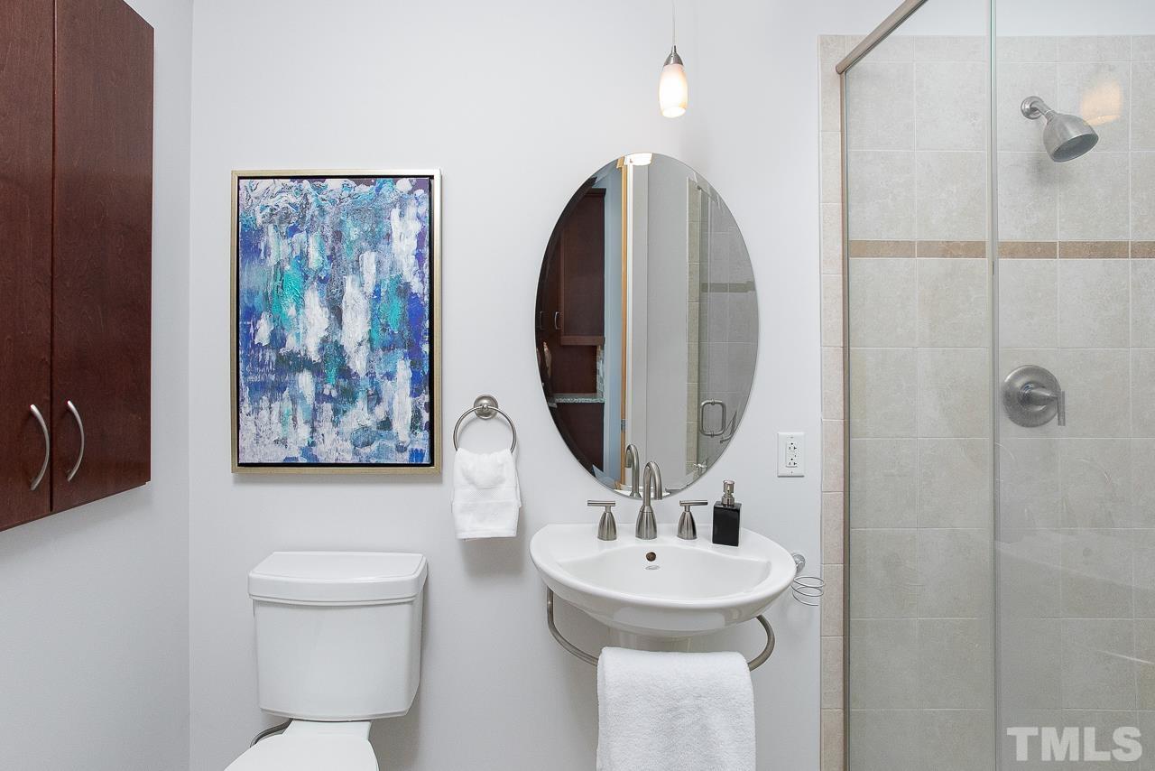 2608 Erwin Road, Unit 402 Durham, NC 27705 - Photo 14 of 33 a bathroom with a toilet sink and mirror