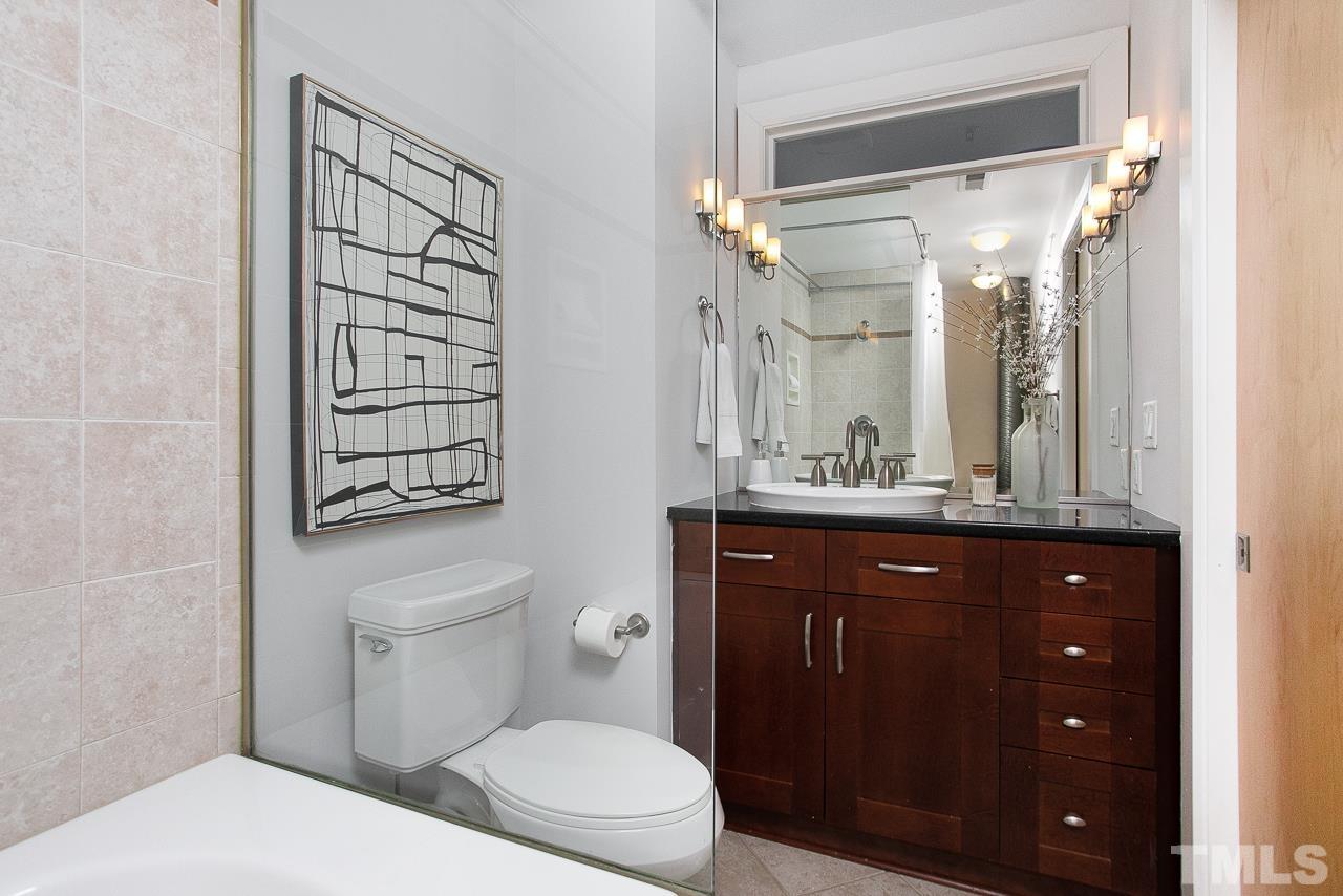 2608 Erwin Road, Unit 402 Durham, NC 27705 - Photo 21 of 33 a bathroom with a granite countertop sink toilet and shower
