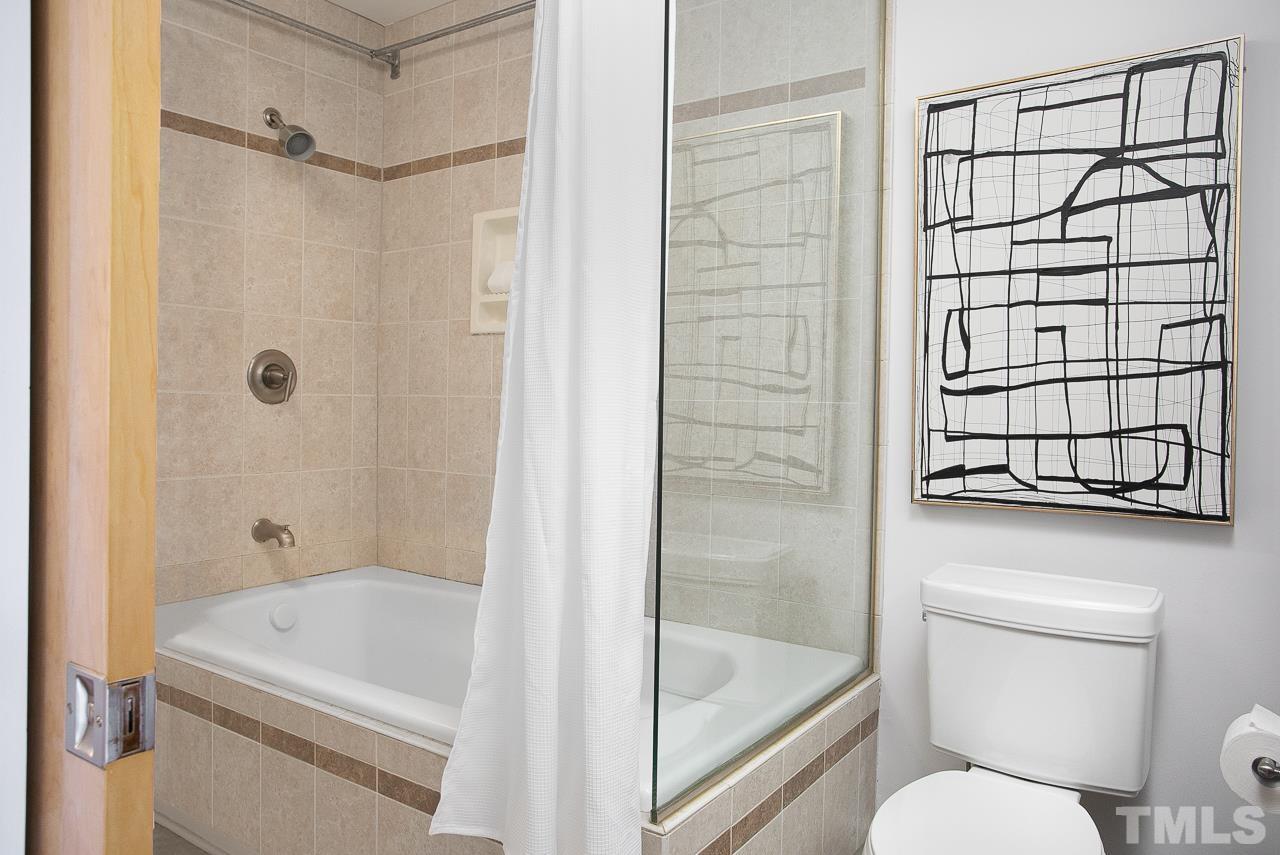 2608 Erwin Road, Unit 402 Durham, NC 27705 - Photo 22 of 33 a bathroom with a shower a toilet and a sink