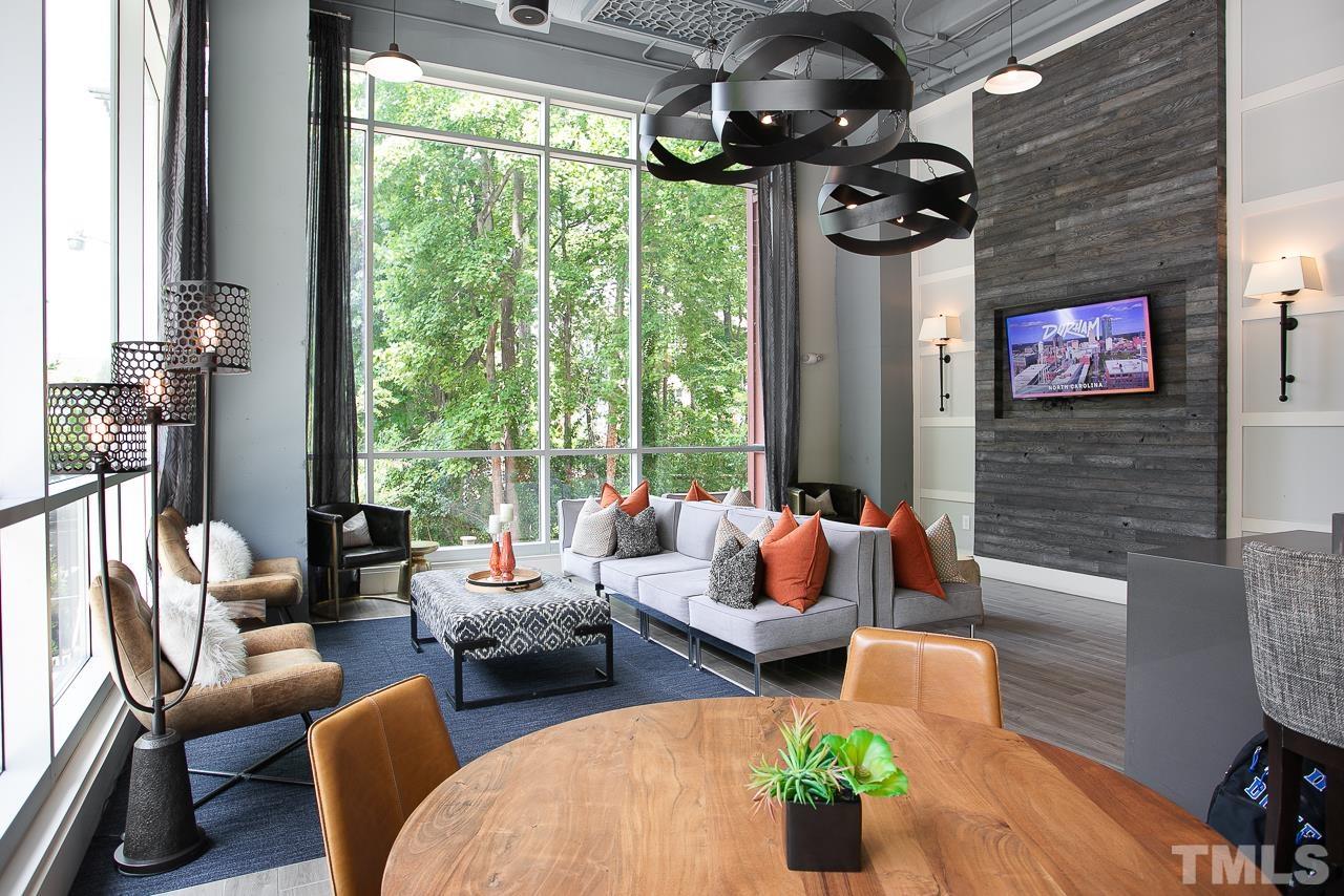2608 Erwin Road, Unit 402 Durham, NC 27705 - Photo 25 of 33 a living room with furniture floor to ceiling window and potted plants