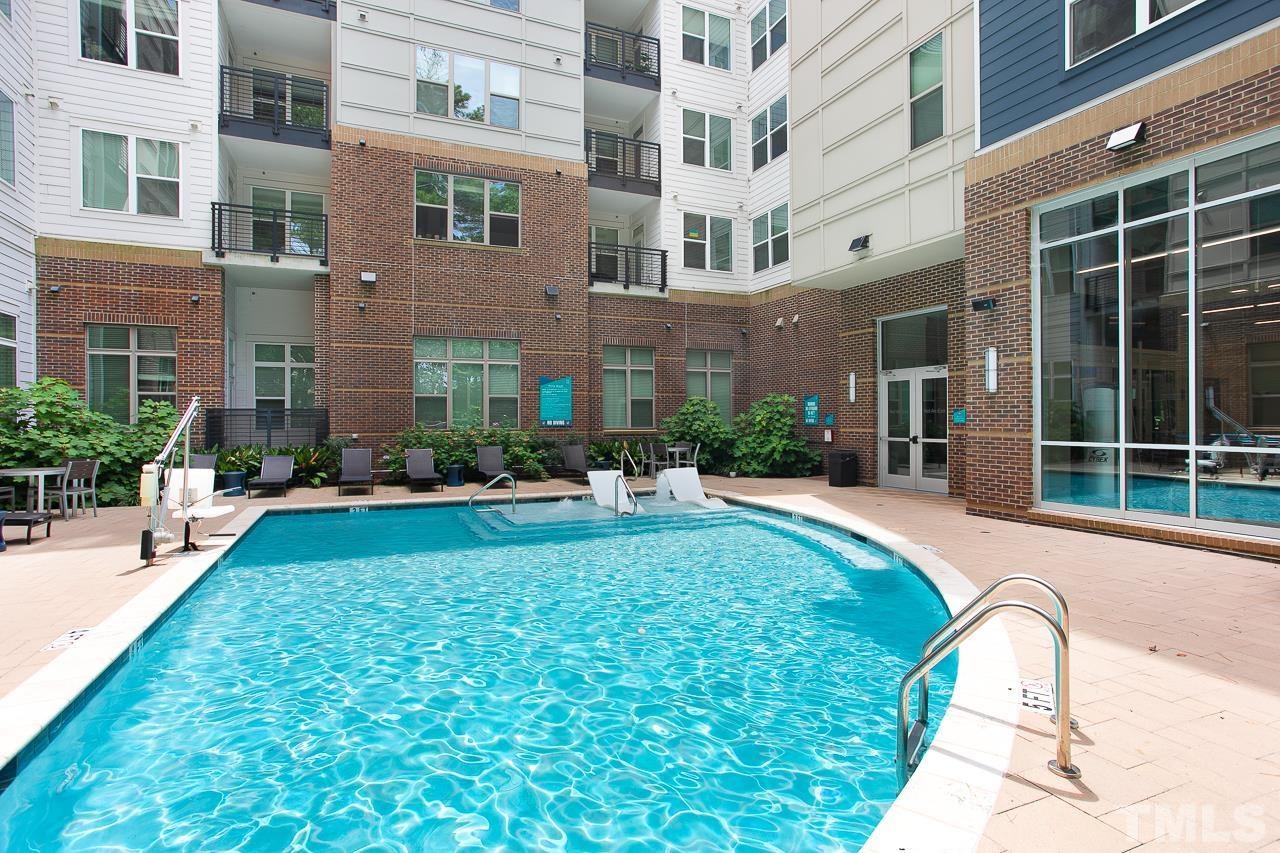 2608 Erwin Road, Unit 402 Durham, NC 27705 - Photo 27 of 33 a view of a house with a swimming pool and a large tree